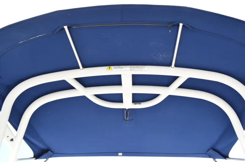 Slide: The Image of Blue canopy of 2016 Chaparral 250 Suncoast boat with white support frame. - 9