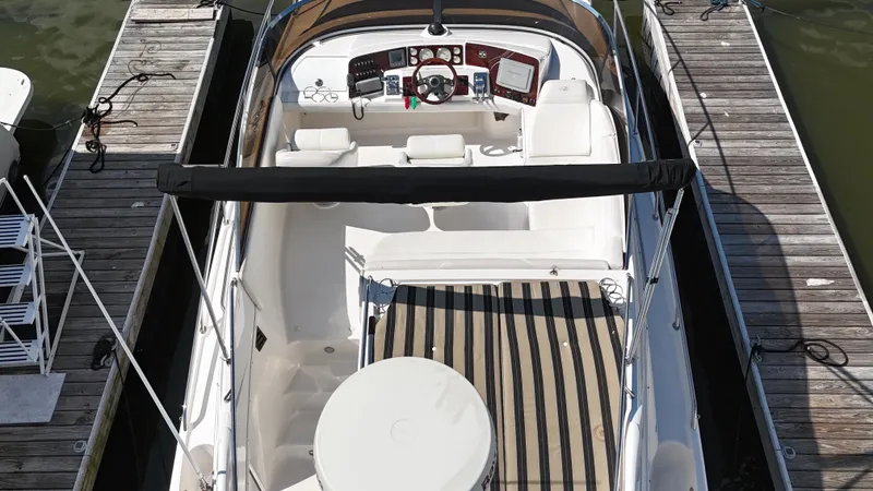 Slide: The Image of 2007 Regal 4080 Flybridge Sedan docked, top view of spacious deck and controls. - 21