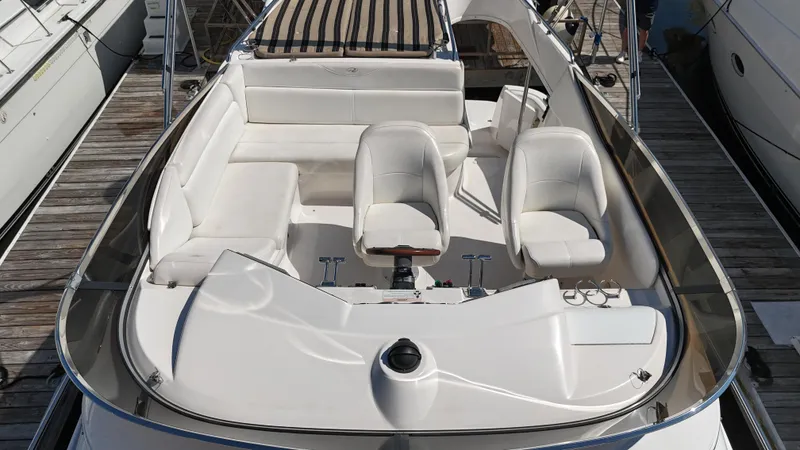 Slide: The Image of 2007 Regal 4080 Flybridge Sedan with white seating and striped canopy, docked at marina. - 22
