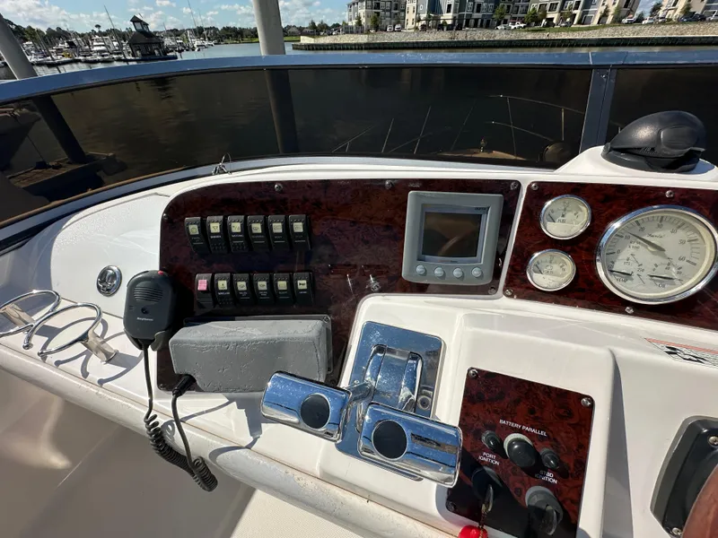 Slide: The Image of Control panel of 2007 Regal 4080 Flybridge Sedan with gauges and switches, docked at marina. - 26