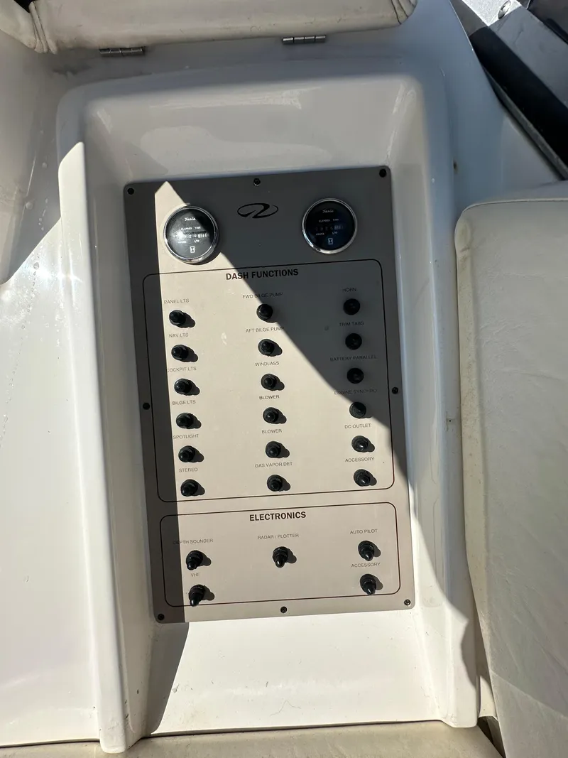 Slide: The Image of Control panel of 2007 Regal 4080 Flybridge Sedan boat with switches and gauges. - 28