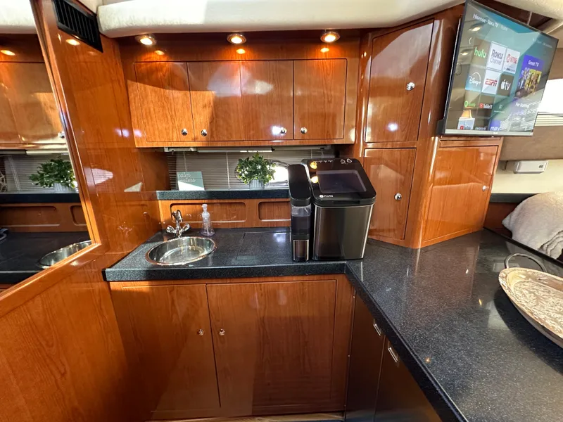 Slide: The Image of Luxurious 2007 Regal 4080 Flybridge Sedan yacht interior with sleek wood cabinetry and modern amenities. - 38