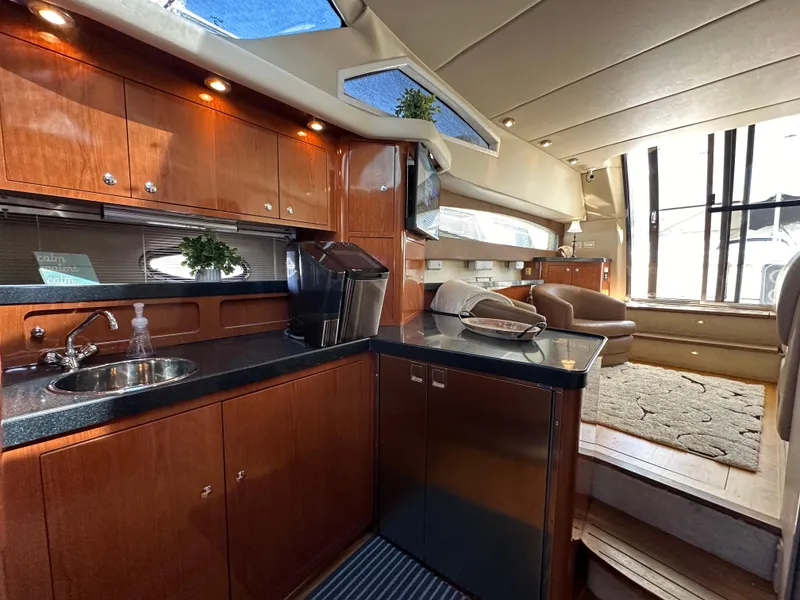 Slide: The Image of Luxurious 2007 Regal 4080 Flybridge Sedan interior with modern kitchen and seating area. - 39