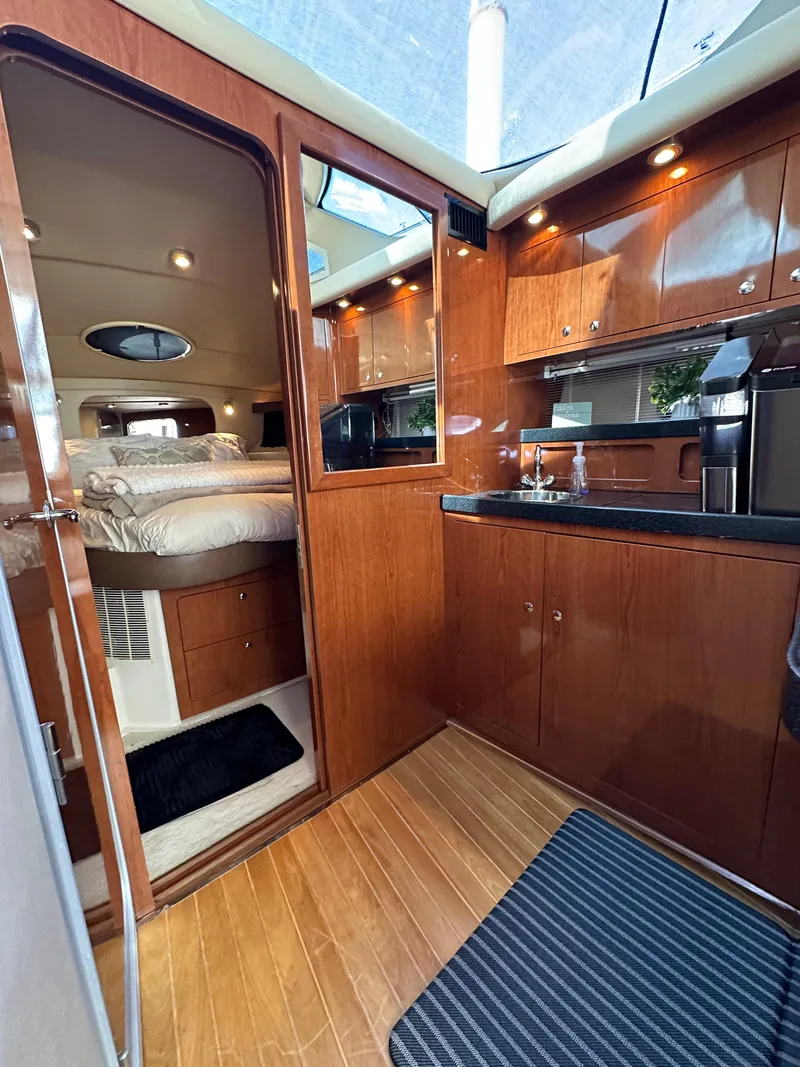 Slide: The Image of Luxurious interior of 2007 Regal 4080 Flybridge Sedan with wood finish and cozy cabin. - 40