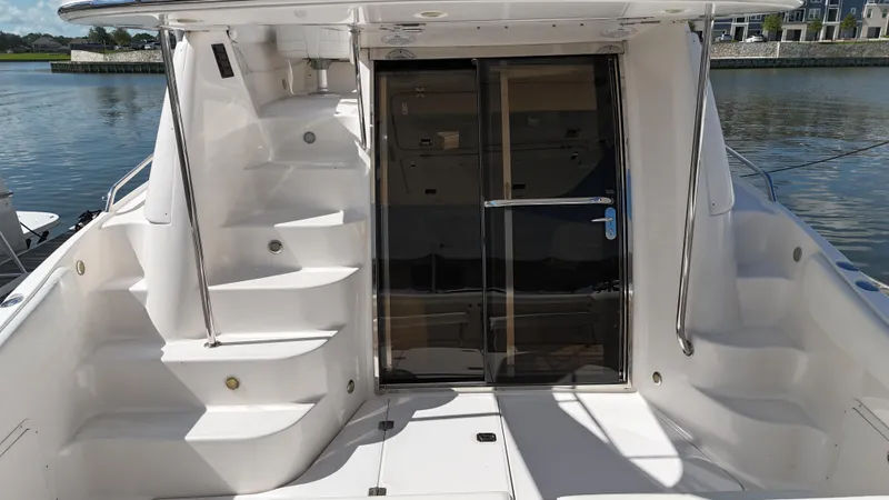 Slide: The Image of 2007 Regal 4080 Flybridge Sedan cruising on water. - 13