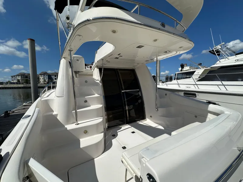 Slide: The Image of 2007 Regal 4080 Flybridge Sedan yacht with sleek white deck and glass doors. - 14