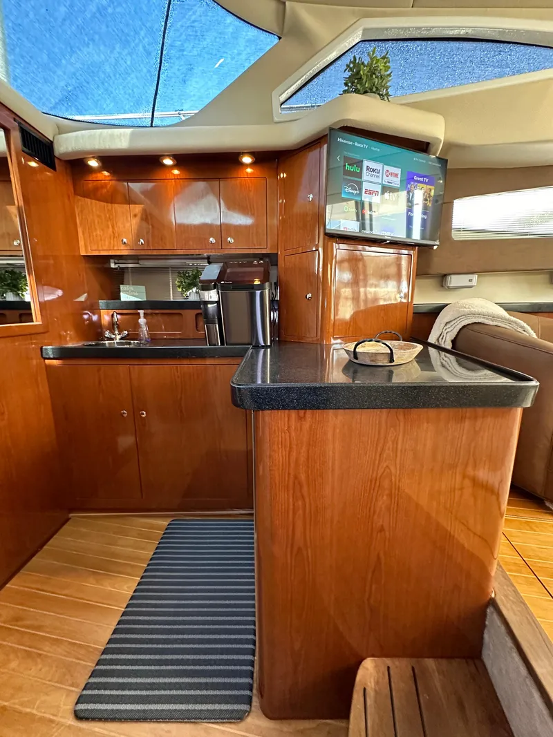 Slide: The Image of Luxurious 2007 Regal 4080 Flybridge Sedan interior with leather chairs and elegant decor. - 37