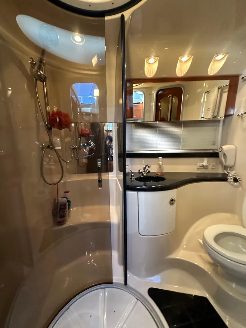 Slide: The Image of Luxurious cabin interior of 2007 Regal 4080 Flybridge Sedan with elegant bedding and wood accents. - 46