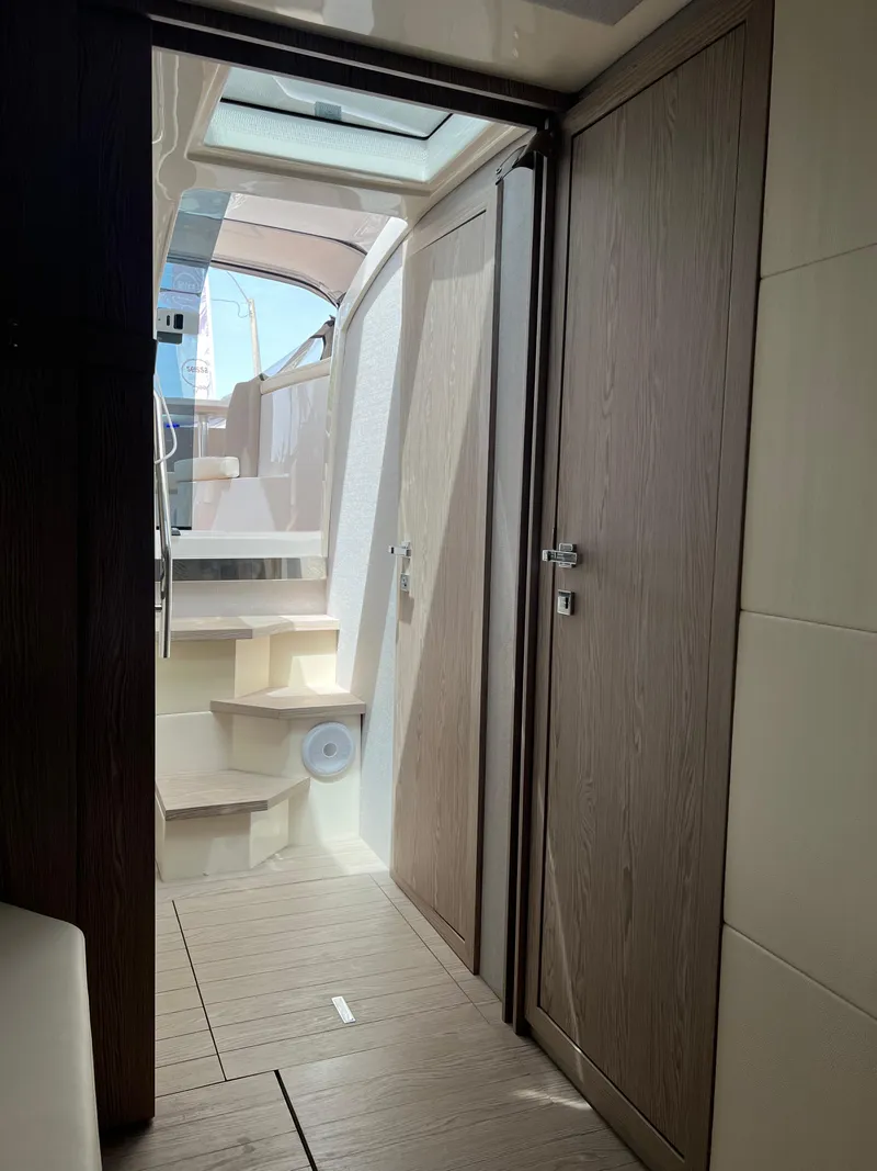 Slide: The Image of Interior view of 2024 Sessa Marine C36 IB yacht, featuring modern wood finishes and staircase. - 14