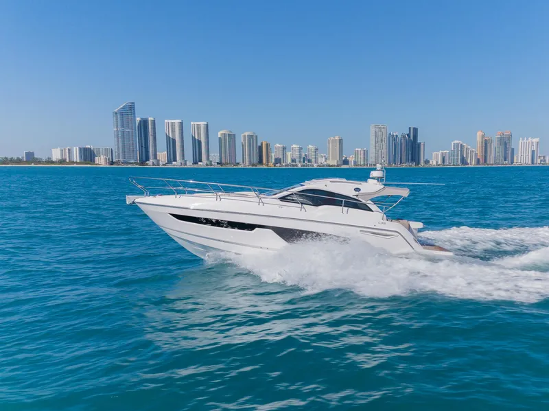 Slide: The Image of 2024 Sessa Marine C36 IB yacht cruising near city skyline. - 2
