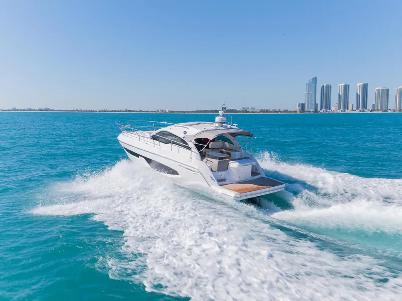 Slide: The Image of 2024 Sessa Marine C36 IB yacht cruising on blue ocean near city skyline. - 6