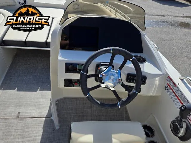 Slide: The Image of 2023 Stingray 192 SC boat interior with steering wheel and dashboard, Sunrise Marine logo visible. - 14