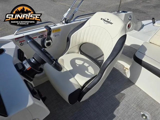Slide: The Image of 2023 Stingray 192 SC boat interior with steering wheel and captain's seat. - 15