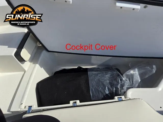 Slide: The Image of 2023 Stingray 192 SC cockpit cover storage compartment, Sunrise Marine & Motorsports logo. - 18