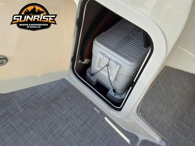 Slide: The Image of 2023 Stingray 192 SC boat storage compartment with cooler, Sunrise Marine logo visible. - 21