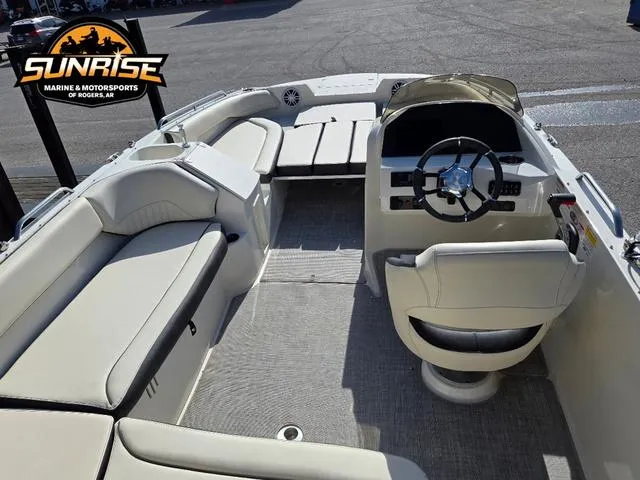 Slide: The Image of 2023 Stingray 192 SC boat interior with seating and steering wheel, at Sunrise Marine. - 4