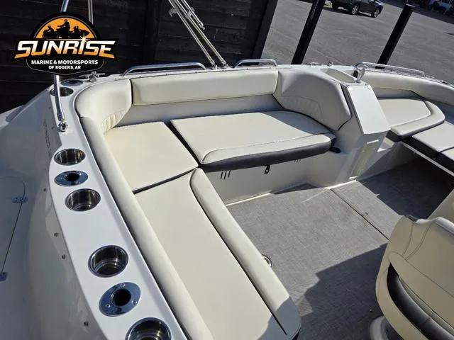 Slide: The Image of 2023 Stingray 192 SC boat interior with white seating and cup holders. - 5