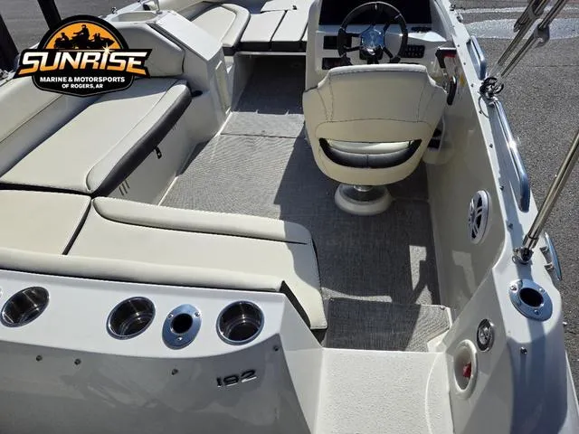 Slide: The Image of 2023 Stingray 192 SC boat interior with seating and steering wheel, Sunrise Marine logo visible. - 6