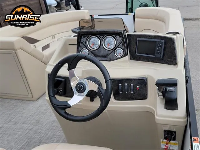 Slide: The Image of 2024 SunCatcher Select 320RCX boat dashboard with steering wheel and control panel. - 10