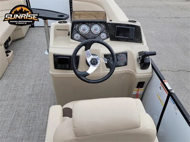 Slide: The Image of 2024 SunCatcher Select 320RCX boat dashboard with steering wheel and controls. - 11