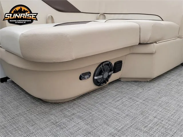 Slide: The Image of 2024 SunCatcher Select 320RCX boat interior with beige seating and speaker system. - 12