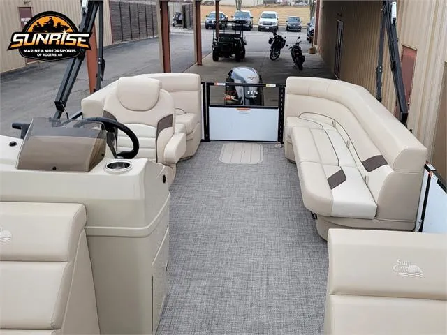Slide: The Image of 2024 SunCatcher Select 320RCX pontoon boat interior with beige seating and steering console. - 17