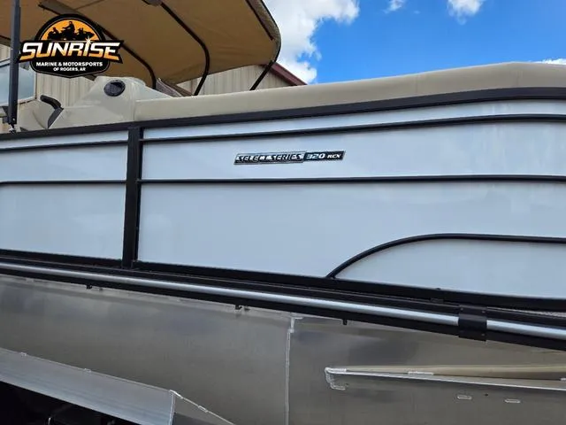 Slide: The Image of 2024 SunCatcher Select 320RCX pontoon boat with canopy under a blue sky. - 28