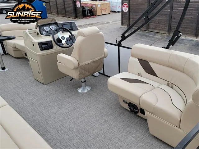 Slide: The Image of 2024 SunCatcher Select 320RCX boat interior with beige seating and steering console. - 5