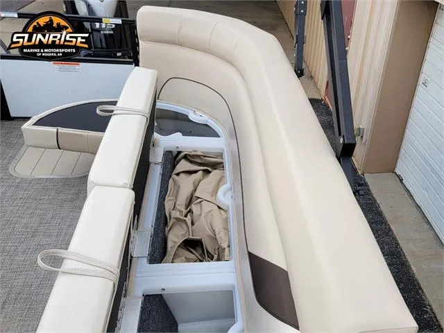 Slide: The Image of 2024 SunCatcher Select 320RCX boat interior with beige seating and storage compartments. - 8