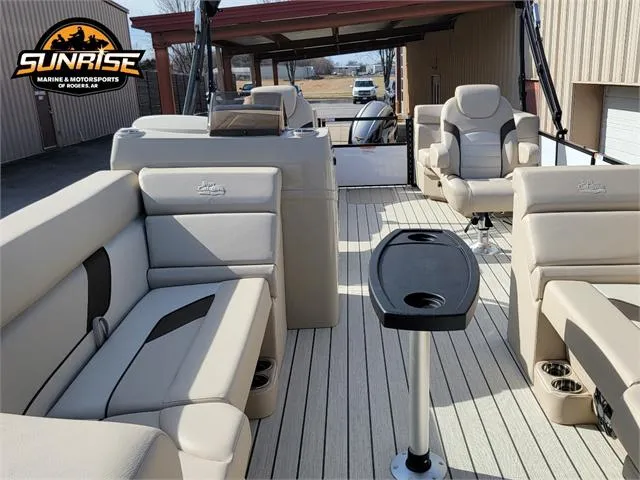 Slide: The Image of 2024 SunCatcher Select 20RC pontoon boat interior with beige seating and table. - 11