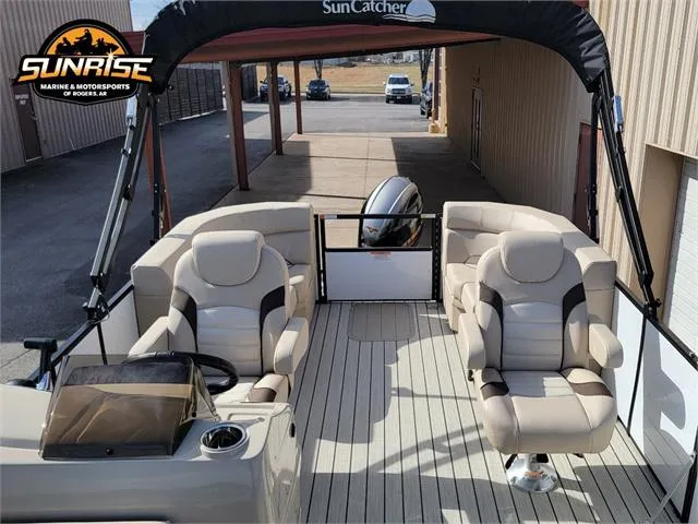 Slide: The Image of 2024 SunCatcher Select 20RC pontoon boat interior with plush seating and steering console. - 12