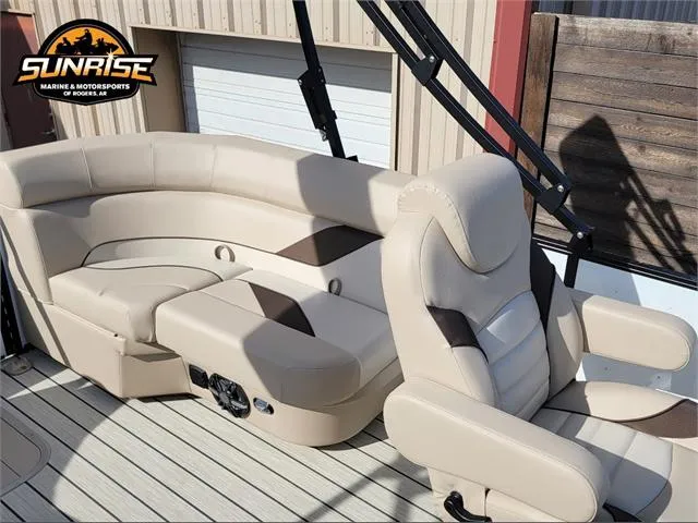 Slide: The Image of 2024 SunCatcher Select 20RC boat interior with beige seating and Sunrise Marine logo. - 22