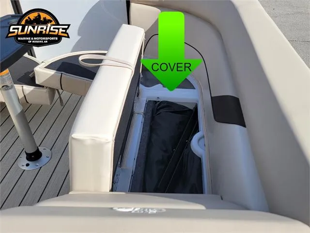 Slide: The Image of 2024 SunCatcher Select 20RC boat storage compartment with cover, featuring beige seating. - 27