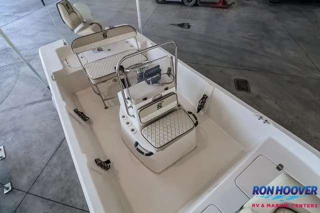Slide: The Image of 2020 Carolina Skiff 178 boat interior with seating and console, displayed indoors. - 10