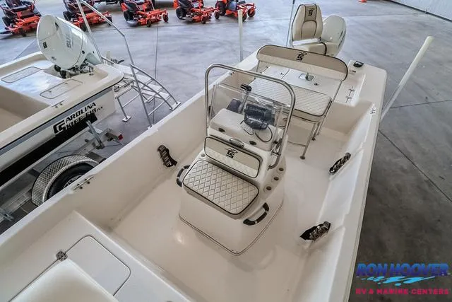 Slide: The Image of 2020 Carolina Skiff 178 boat interior with seating and steering console in showroom. - 11