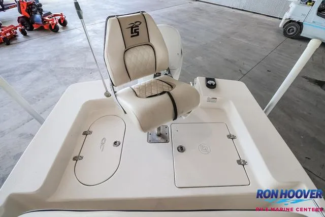 Slide: The Image of 2020 Carolina Skiff 178 boat interior with cushioned seat and storage compartments. - 15