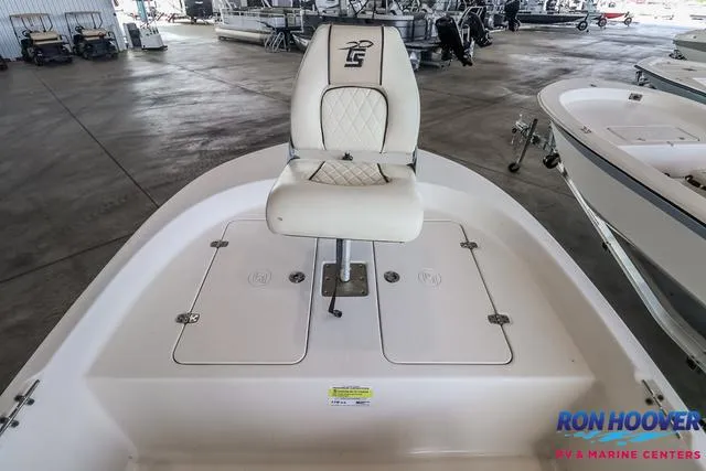 Slide: The Image of 2020 Carolina Skiff 178 boat with white seating in a showroom. - 18