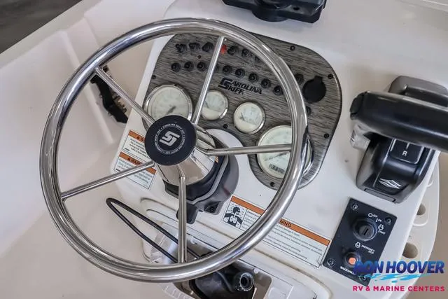 Slide: The Image of Carolina Skiff 178 boat dashboard with steering wheel and control panel, 2020 model. - 19