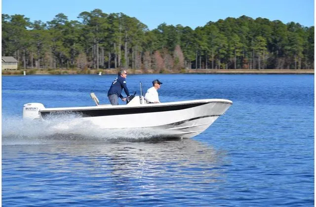 Slide: The Image of 2020 Carolina Skiff 178 boat cruising on a lake with two passengers. - 28