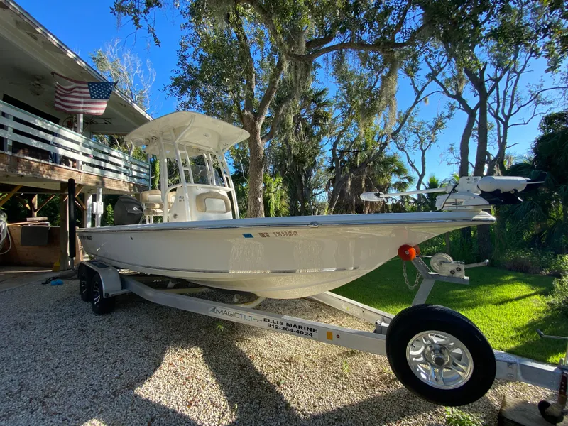 The Image of 2017 Key West 230 Bay Reef boat on trailer, parked in a sunny yard. - 0