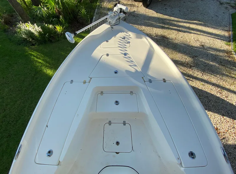 Slide: The Image of 2017 Key West 230 Bay Reef boat deck with trolling motor, parked on gravel. - 14