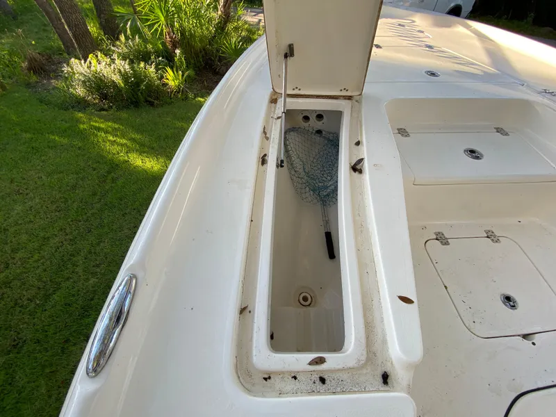 Slide: The Image of 2017 Key West 230 Bay Reef boat with open storage compartment and fishing net. - 19