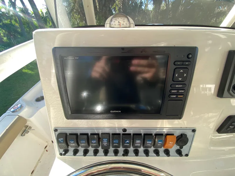 Slide: The Image of Key West 230 Bay Reef 2017 dashboard with Garmin display and control panel. - 29