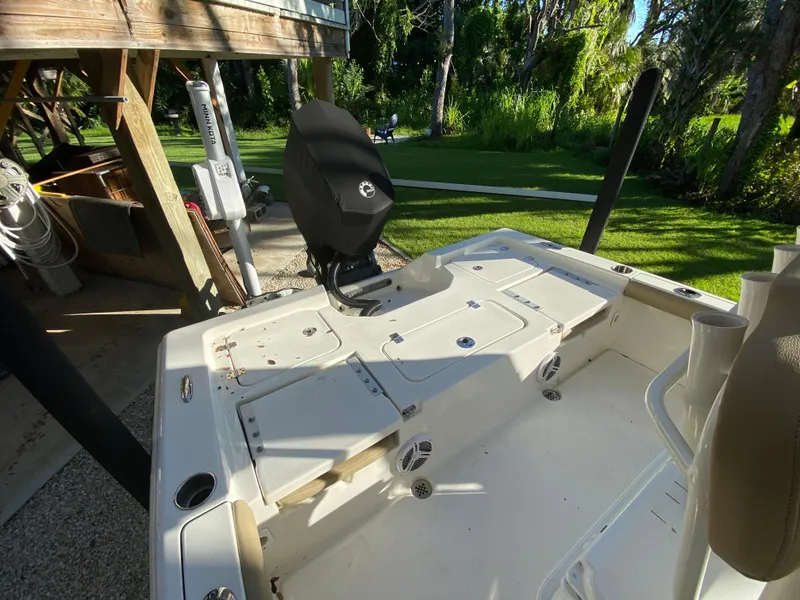 Slide: The Image of 2017 Key West 230 Bay Reef boat, outdoor setting, motor covered, sunny day. - 32
