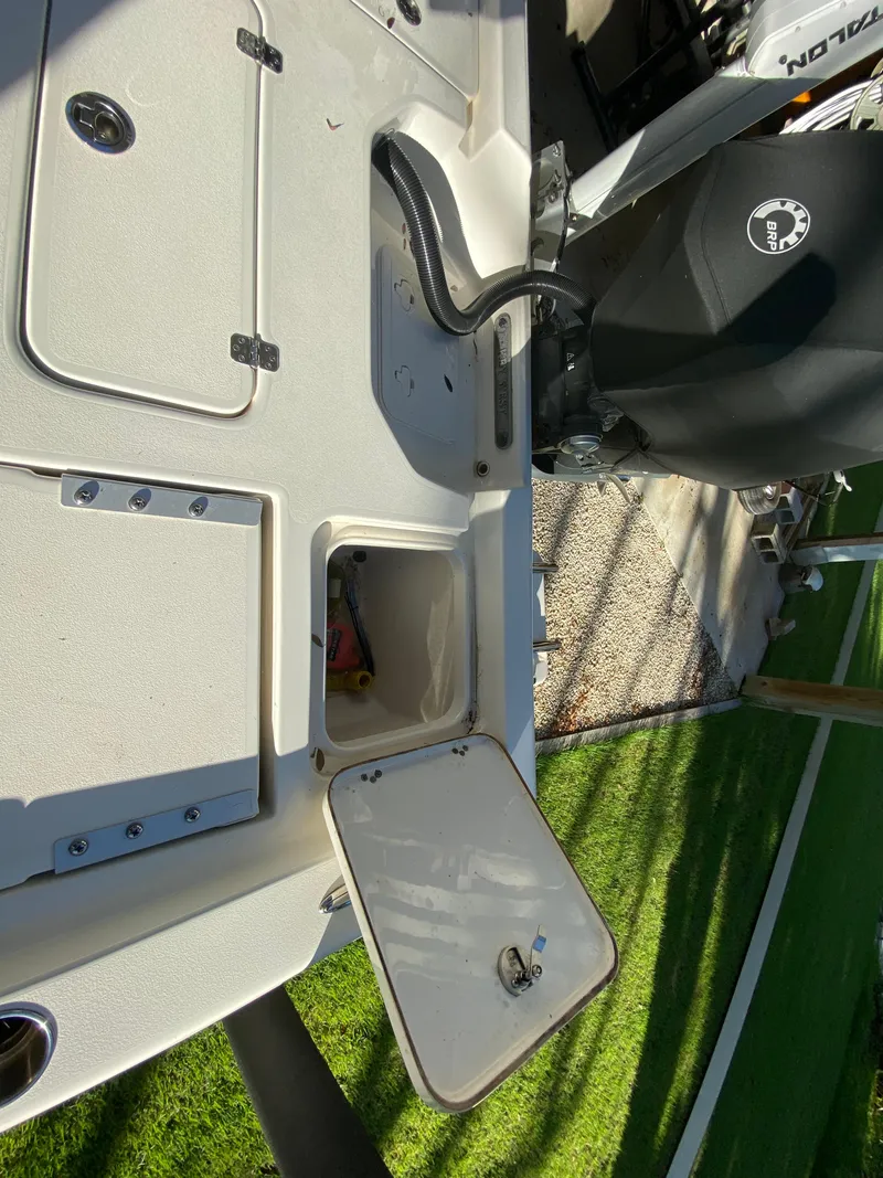 Slide: The Image of 2017 Key West 230 Bay Reef boat deck with storage compartments and motor. - 35