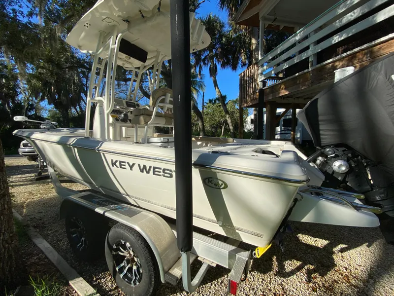 Slide: The Image of 2017 Key West 230 Bay Reef boat on trailer, parked outdoors. - 4