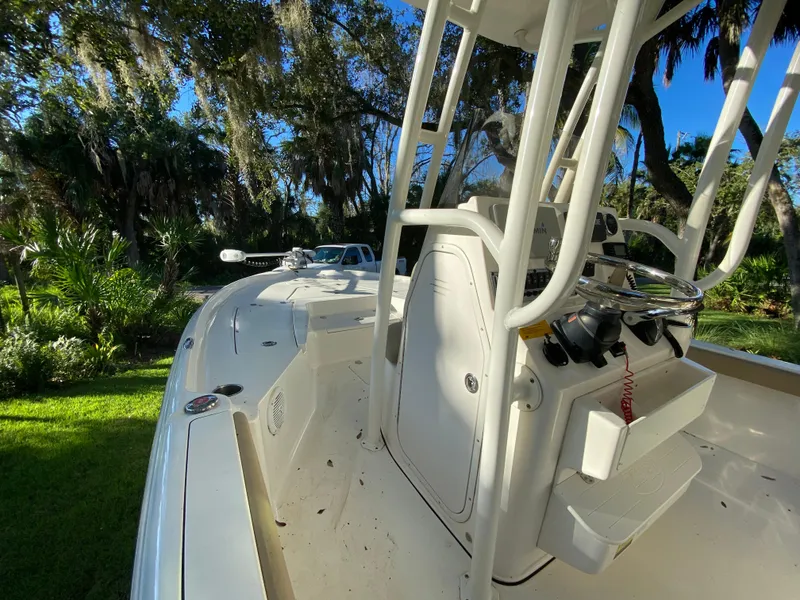 Slide: The Image of 2017 Key West 230 Bay Reef boat in lush, sunny outdoor setting. - 41