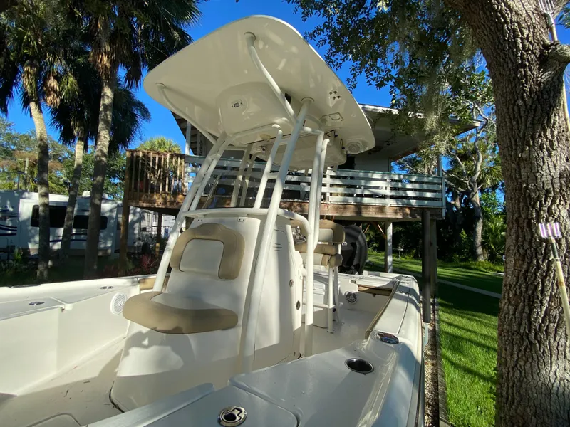 Slide: The Image of 2017 Key West 230 Bay Reef boat with T-top, parked outdoors. - 6