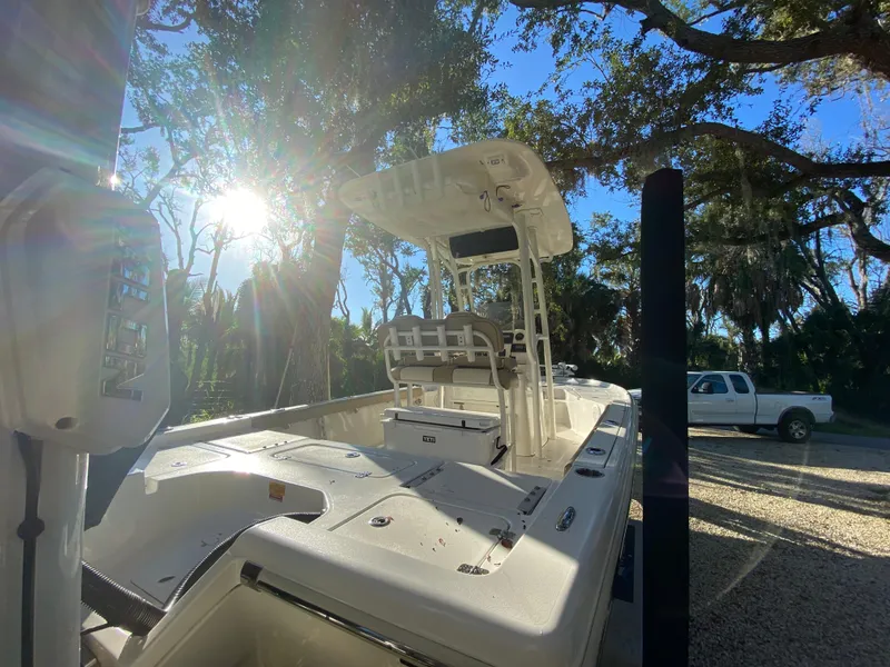 Slide: The Image of 2017 Key West 230 Bay Reef boat in sunny outdoor setting, surrounded by trees. - 7