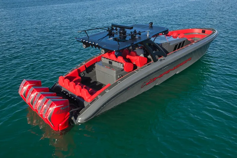 Slide: The Image of 2021 Midnight Express 43' Solstice boat with red seating and multiple outboard engines on blue water. - 10